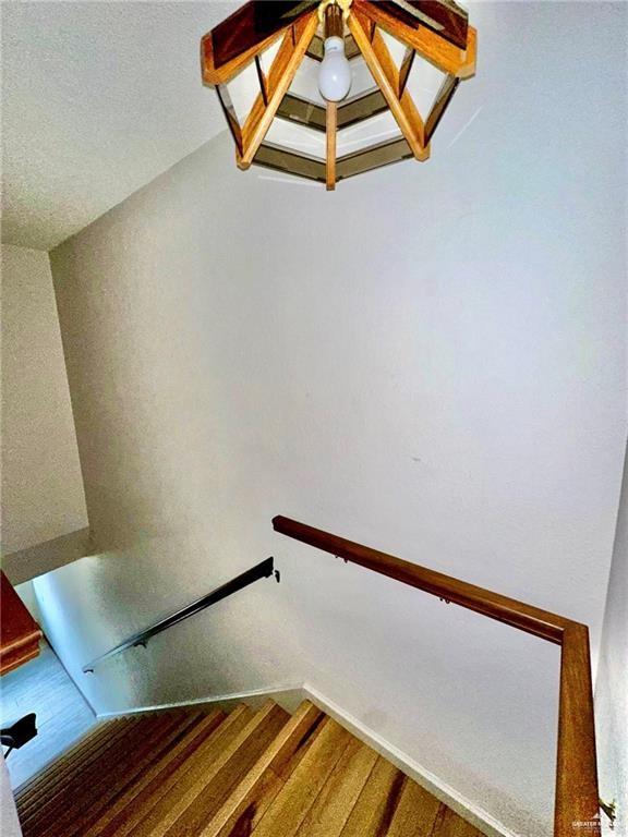 staircase with hardwood / wood-style floors