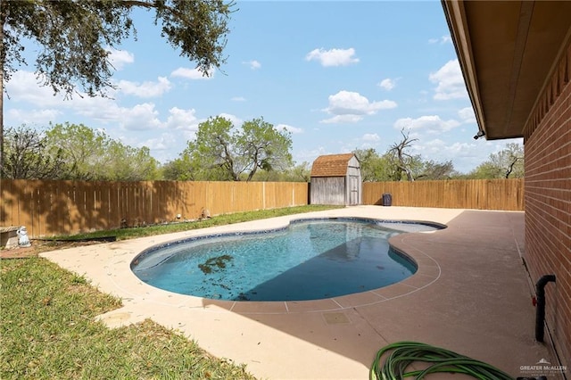 view of pool with a fenced in pool, an outbuilding, a storage shed, a patio area, and a fenced backyard