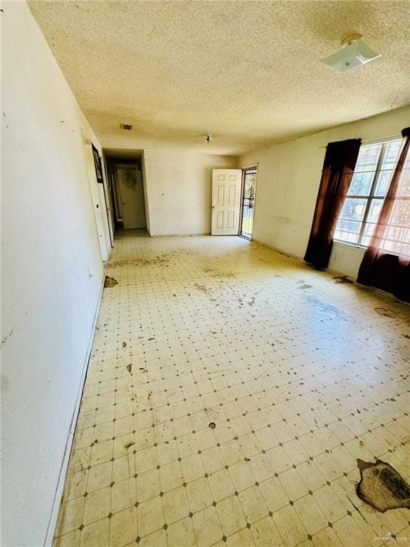 spare room with a textured ceiling