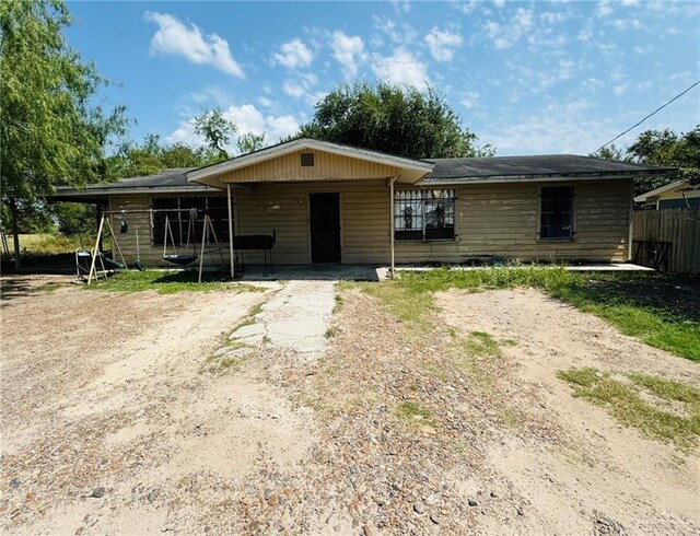 single story home featuring a carport