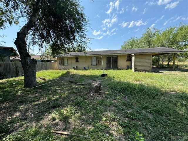 back of house with a yard and a carport