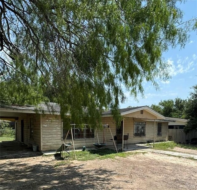 ranch-style home featuring a carport