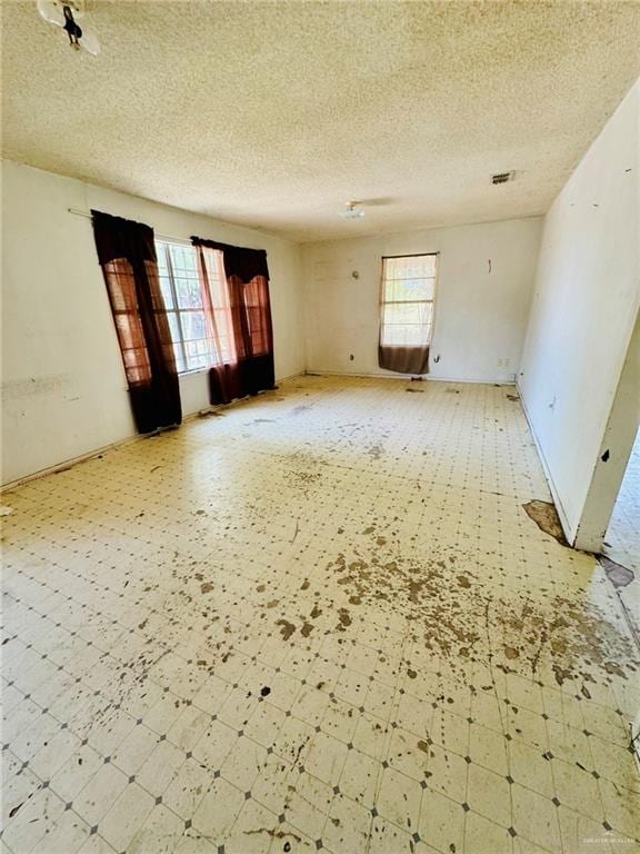 spare room featuring a textured ceiling