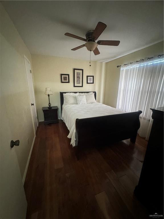 bedroom with dark hardwood / wood-style floors and ceiling fan