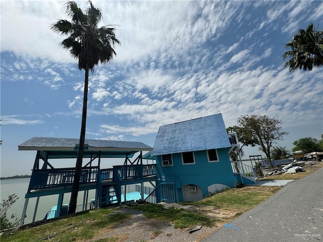 exterior space with a deck with water view