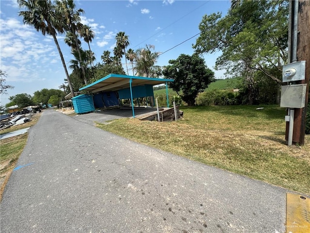 view of front of home with a carport and a front lawn