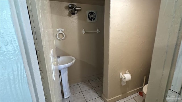 bathroom featuring tile patterned flooring and toilet