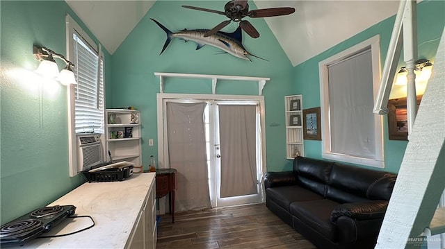 living room with vaulted ceiling, ceiling fan, and dark wood-type flooring