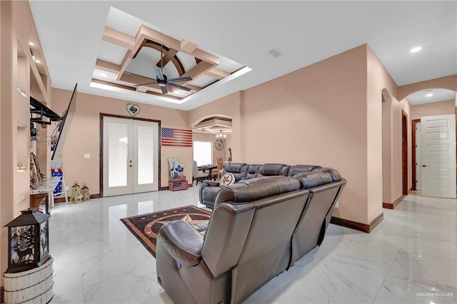 2000 Shelby St, Mission, TX 78572 - living room featuring arched walkways, coffered ceiling, a ceiling fan, french doors, and light marble finish flooring