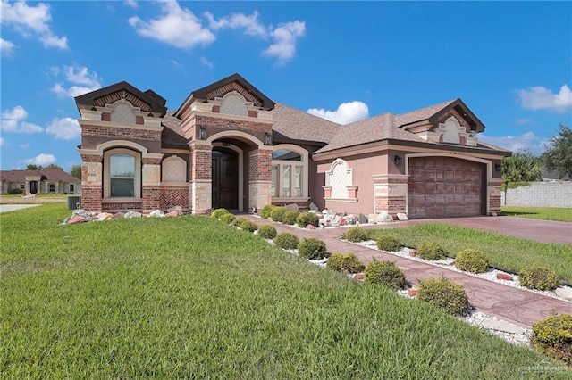 2000 Shelby St, Mission, TX 78572 - view of front of house featuring a front yard, brick siding, a garage, concrete driveway, and stone siding