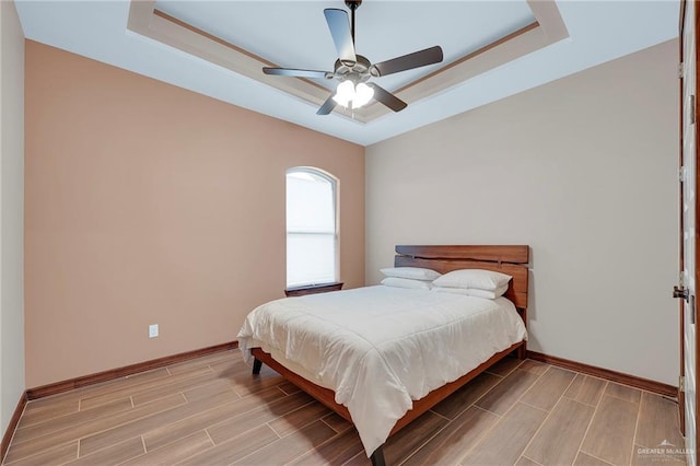 2000 Shelby St, Mission, TX 78572 - bedroom featuring a raised ceiling, wood finish floors, and baseboards