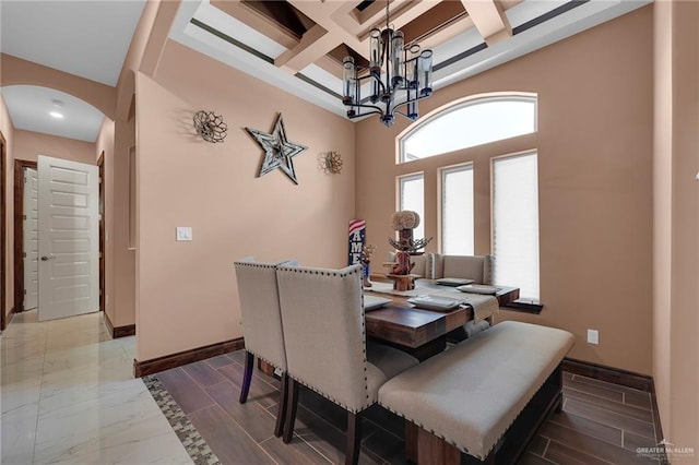2000 Shelby St, Mission, TX 78572 - dining area with arched walkways, coffered ceiling, baseboards, a chandelier, and beamed ceiling