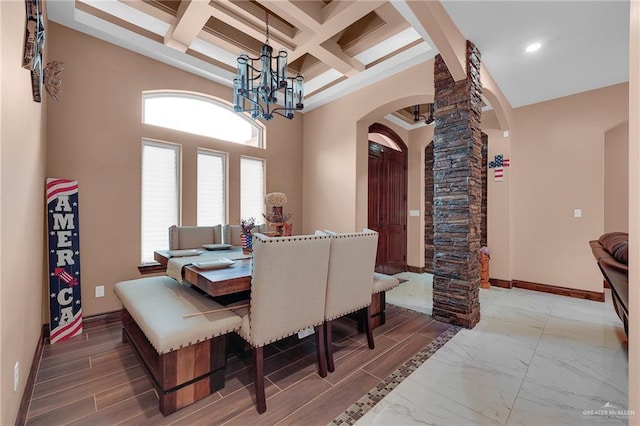 2000 Shelby St, Mission, TX 78572 - dining room featuring arched walkways, ornate columns, beamed ceiling, a chandelier, and baseboards