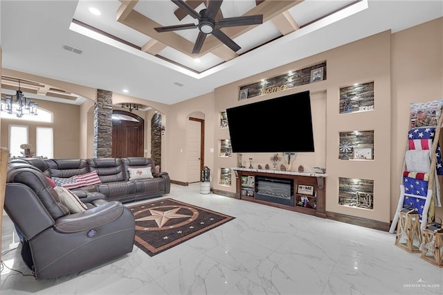 2000 Shelby St, Mission, TX 78572 - living room featuring arched walkways, ceiling fan, marble look tile flooring, baseboards, and a tray ceiling