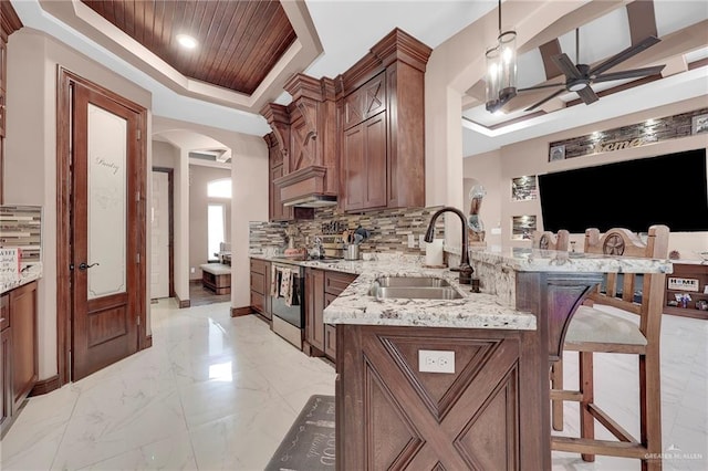 2000 Shelby St, Mission, TX 78572 - kitchen with a raised ceiling, a sink, stainless steel electric range oven, a ceiling fan, and arched walkways