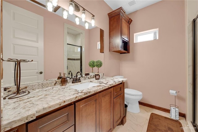 2000 Shelby St, Mission, TX 78572 - bathroom with a shower stall, vanity, toilet, marble look tiles, and baseboards
