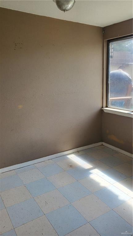 601 E Ricky Crossland Ave, Elsa, TX 78543 - unfurnished room featuring baseboards and tile patterned floors