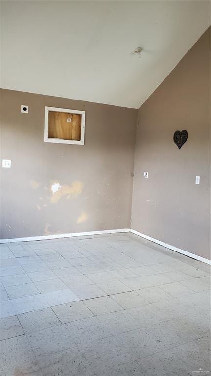 601 E Ricky Crossland Ave, Elsa, TX 78543 - spare room featuring baseboards and lofted ceiling