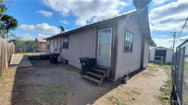 601 E Ricky Crossland Ave, Elsa, TX 78543 - view of side of home with entry steps, a fenced backyard, and metal roof