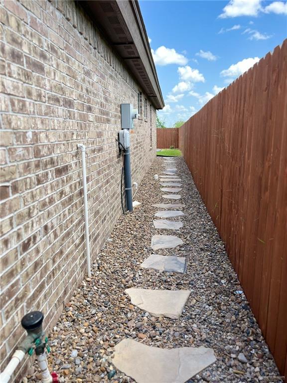 442 La Villita Dr, Donna, TX 78537 - view of side of property with a fenced backyard and brick siding