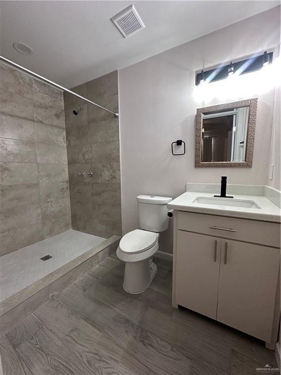 218 W Eller Ave, Pharr, TX 78577 - full bathroom with vanity and a tile shower