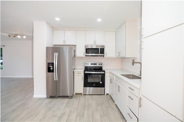 218 W Eller Ave, Pharr, TX 78577 - kitchen featuring stainless steel appliances, light wood-style flooring, light countertops, white cabinets, and recessed lighting