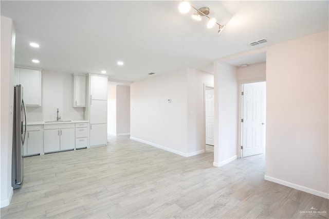 218 W Eller Ave, Pharr, TX 78577 - unfurnished living room featuring light wood-style floors and recessed lighting
