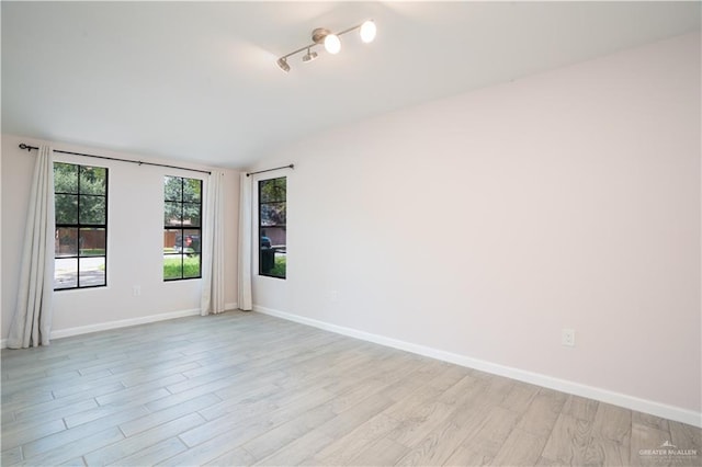 218 W Eller Ave, Pharr, TX 78577 - spare room featuring light wood-style flooring and vaulted ceiling