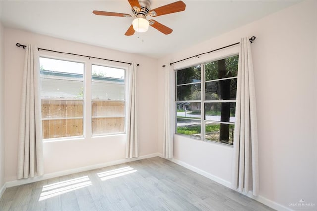 218 W Eller Ave, Pharr, TX 78577 - unfurnished room featuring light wood finished floors, plenty of natural light, and a ceiling fan