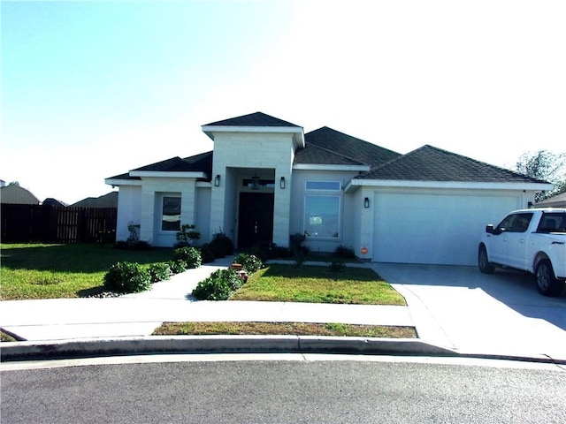 view of front of house featuring a garage and a front yard