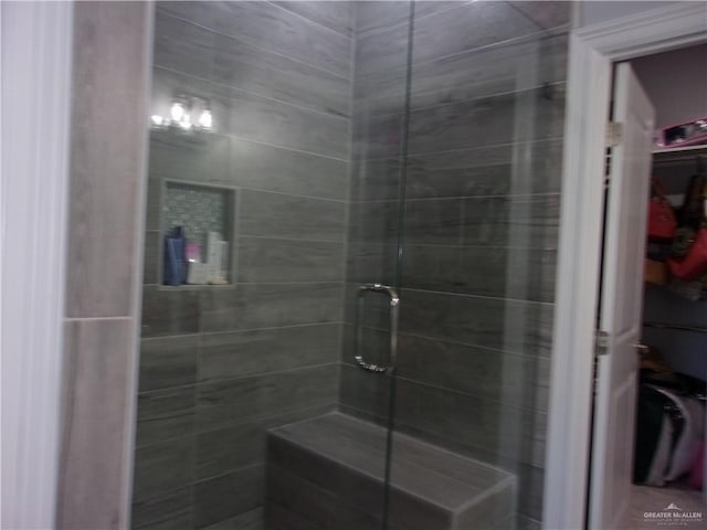 bathroom with a shower with shower door