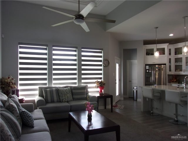 living room featuring ceiling fan and dark wood-type flooring