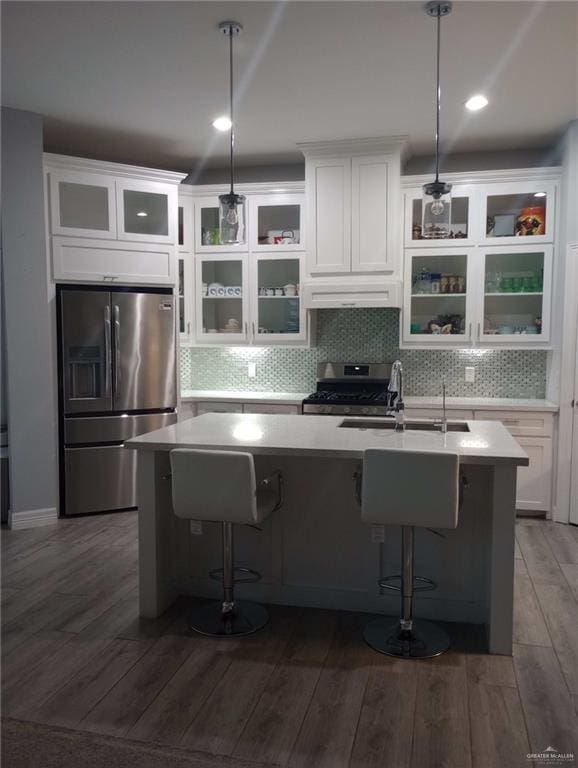 kitchen with custom exhaust hood, a sink, stainless steel appliances, and light countertops