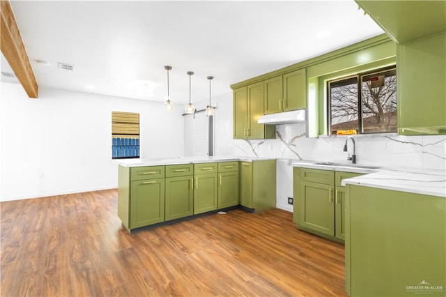 kitchen featuring sink, pendant lighting, and green cabinets