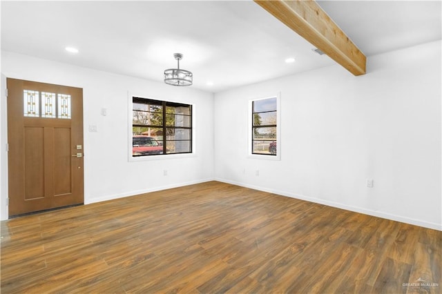 foyer featuring beam ceiling, dark hardwood / wood-style floors, and an inviting chandelier