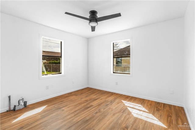 empty room featuring hardwood / wood-style floors and ceiling fan