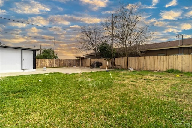 yard at dusk featuring a patio