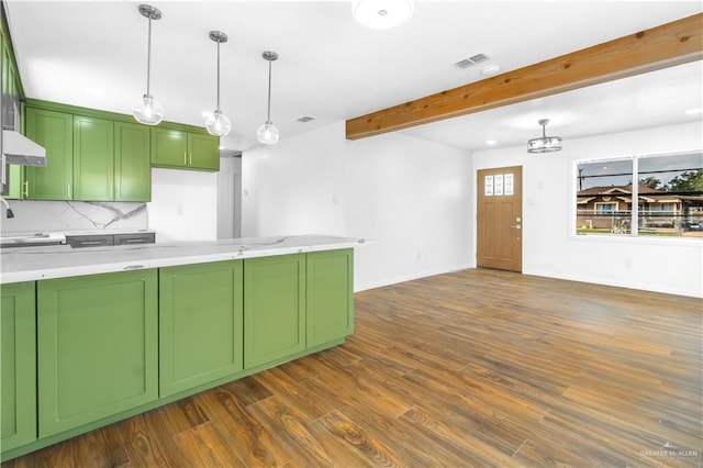 kitchen with decorative backsplash, green cabinets, pendant lighting, and beam ceiling