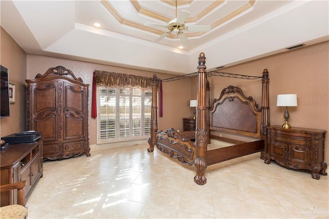 tiled bedroom featuring a tray ceiling