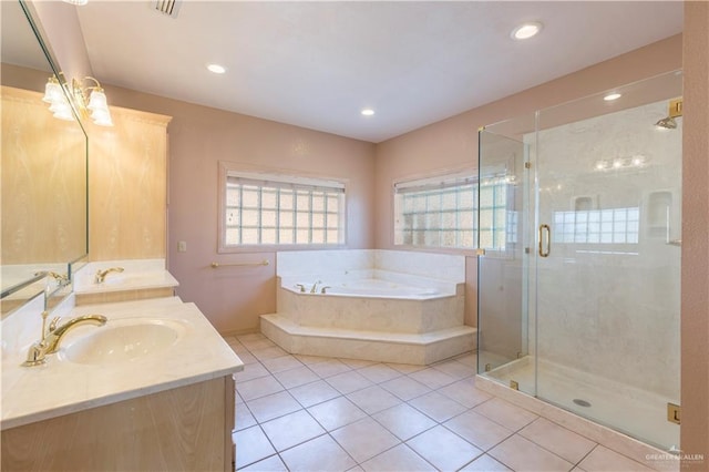 bathroom with tile patterned floors, vanity, and shower with separate bathtub