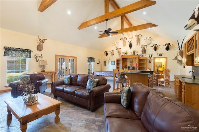 living room with beam ceiling, a wealth of natural light, french doors, and high vaulted ceiling