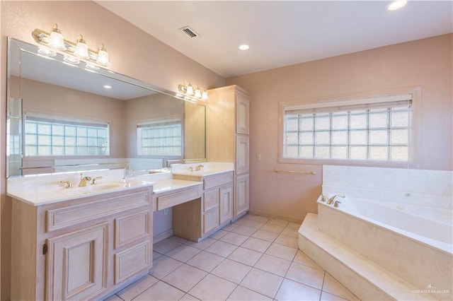 bathroom featuring tile patterned floors, a bathing tub, and vanity