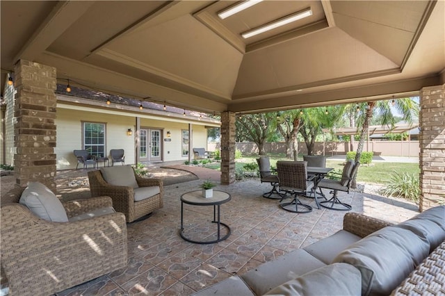 view of patio with french doors, an outdoor living space, and a gazebo