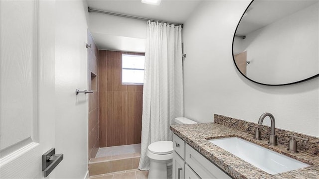 bathroom with tile patterned flooring, toilet, vanity, and curtained shower