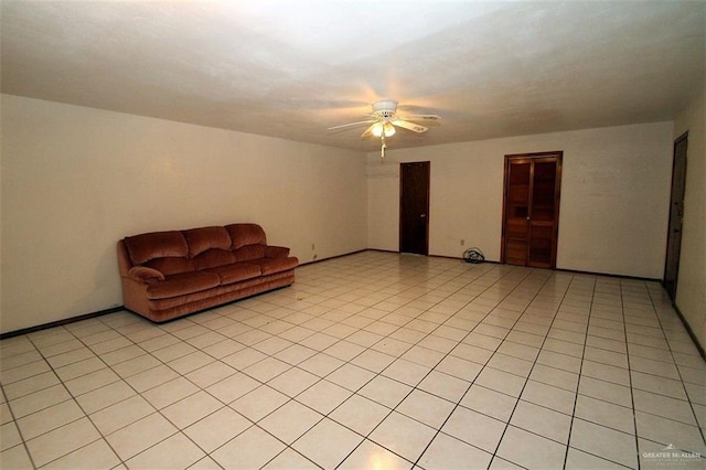 unfurnished living room featuring ceiling fan and light tile patterned floors