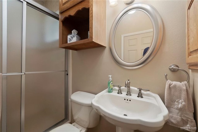 5109 Quince Ave, Mcallen, TX 78501 - bathroom featuring a sink, toilet, and a shower with door