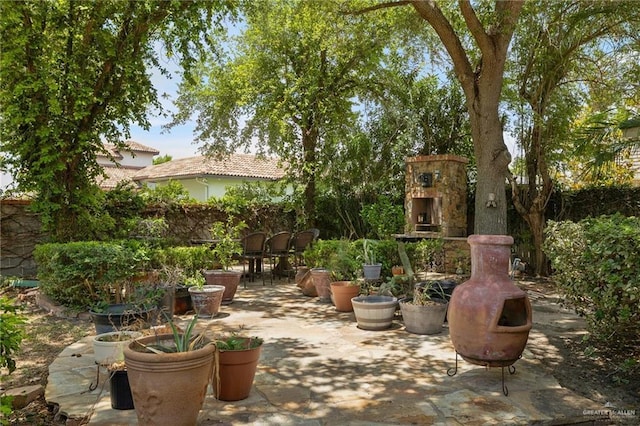 5109 Quince Ave, Mcallen, TX 78501 - view of patio with an outdoor stone fireplace and fence