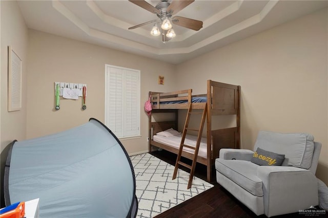 5109 Quince Ave, Mcallen, TX 78501 - bedroom featuring a raised ceiling, light wood-style flooring, and a ceiling fan