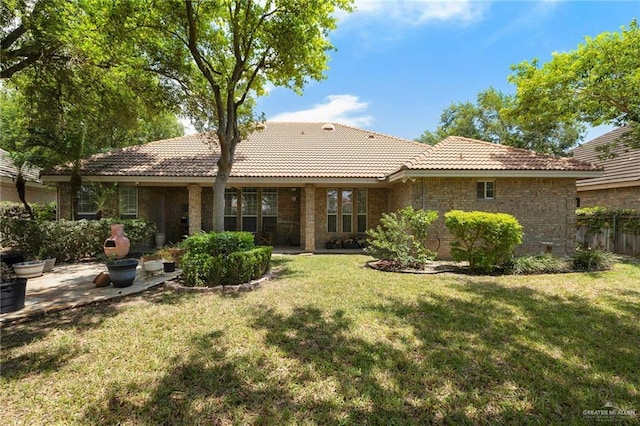5109 Quince Ave, Mcallen, TX 78501 - rear view of house featuring a tiled roof, a patio, and brick siding