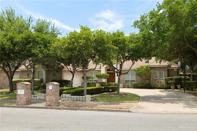 5109 Quince Ave, Mcallen, TX 78501 - obstructed view of property featuring concrete driveway and a tile roof